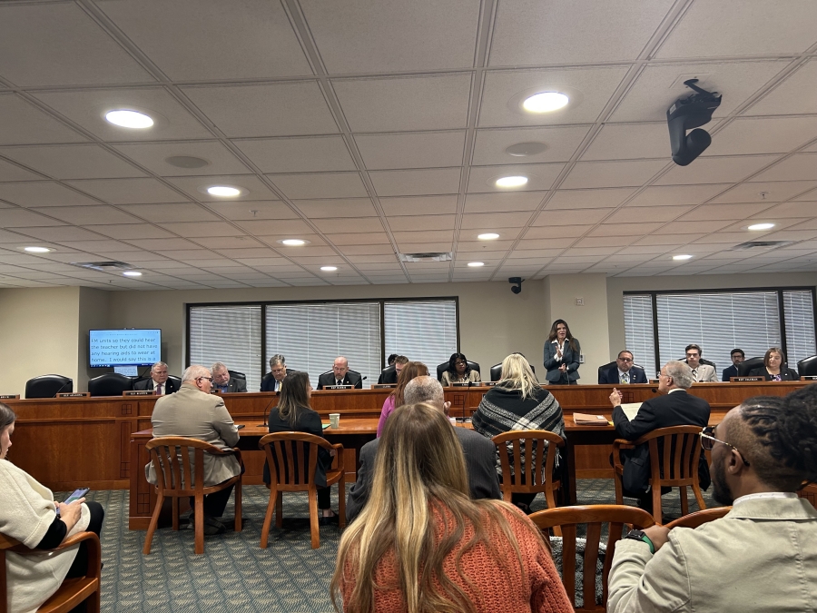 Photo of a panel of State of MI House Representatives sitting behind a table during hearing