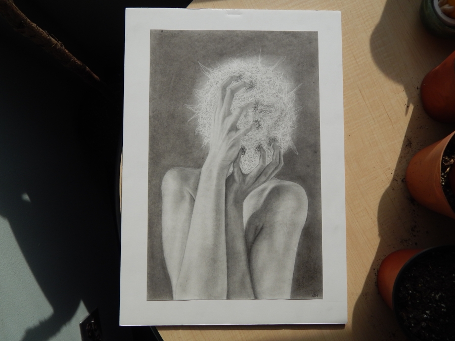 Artist has shared a piece, Panic which depicts a graphite drawing of a needle/light head with hands grabbing face. It is detailed and hand drawn, featuring a centered human figure contrasted against a dark background. The greyscale color lens offers the viewer a heightened perspective of shadow and highlights. The human’s bare arms are in direct view, raised with hands clutching the area of the individual’s head. Bare fingers are extended and tense. The area of the head is a luminous sphere emitting light a